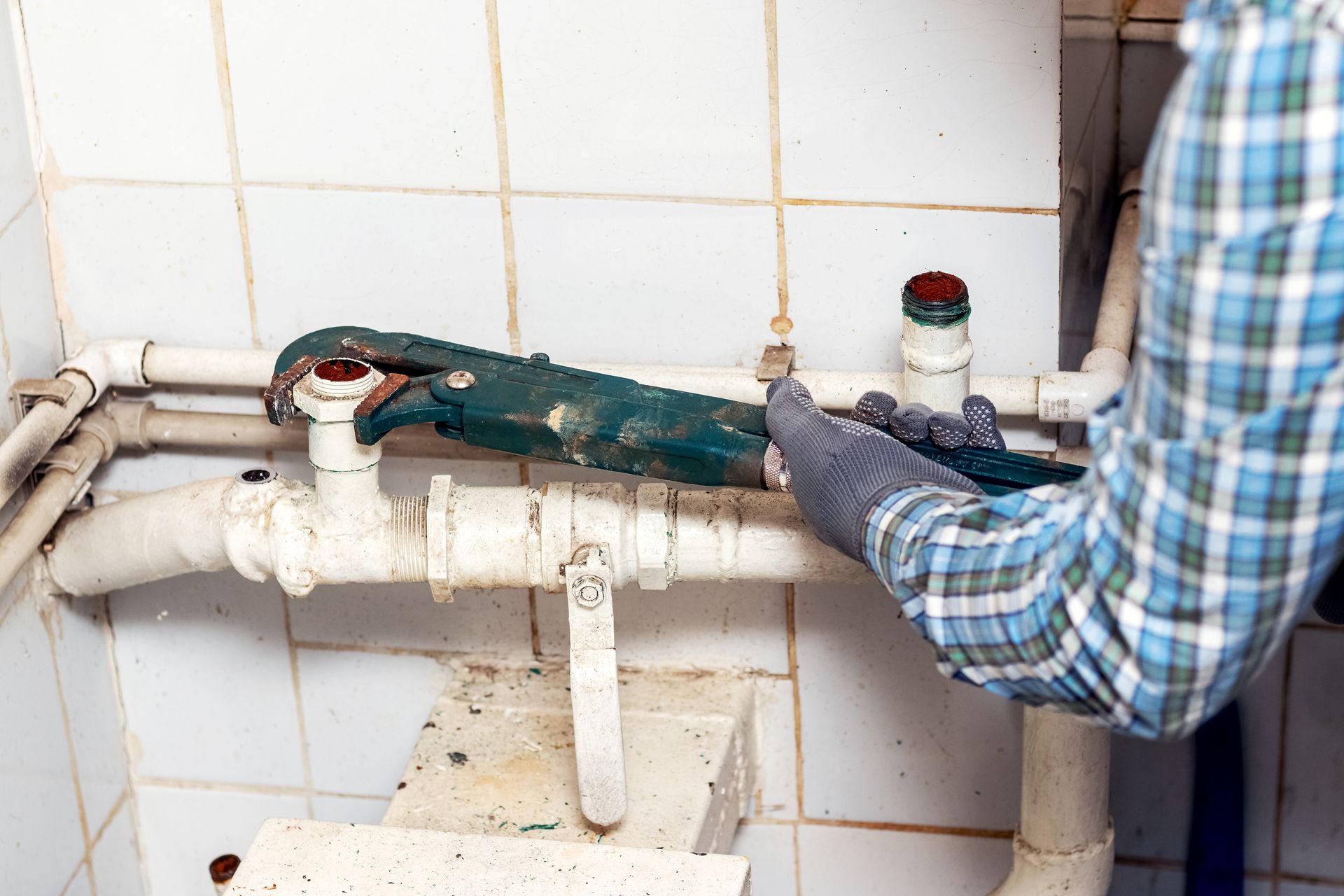 worker uses adjustable wrench tighten nut pipe water supply system