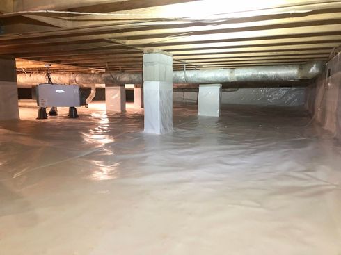 Flooded basement with standing water up to the floor joists and support columns