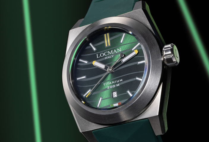 Luxury Locman wristwatch with dark green dial and silver case on a green background