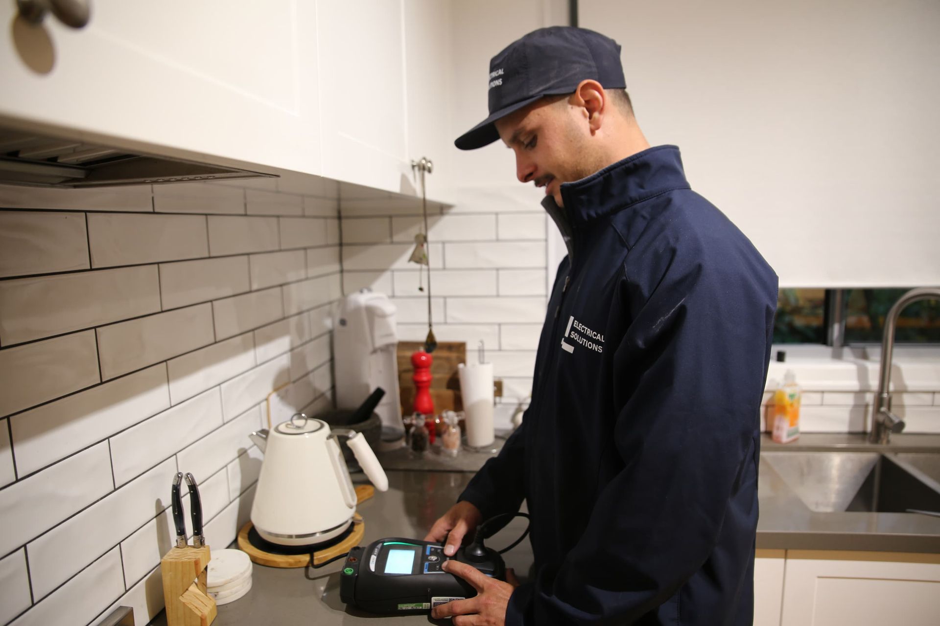 Electrician Checking Appliances - Electrician Gold Coast