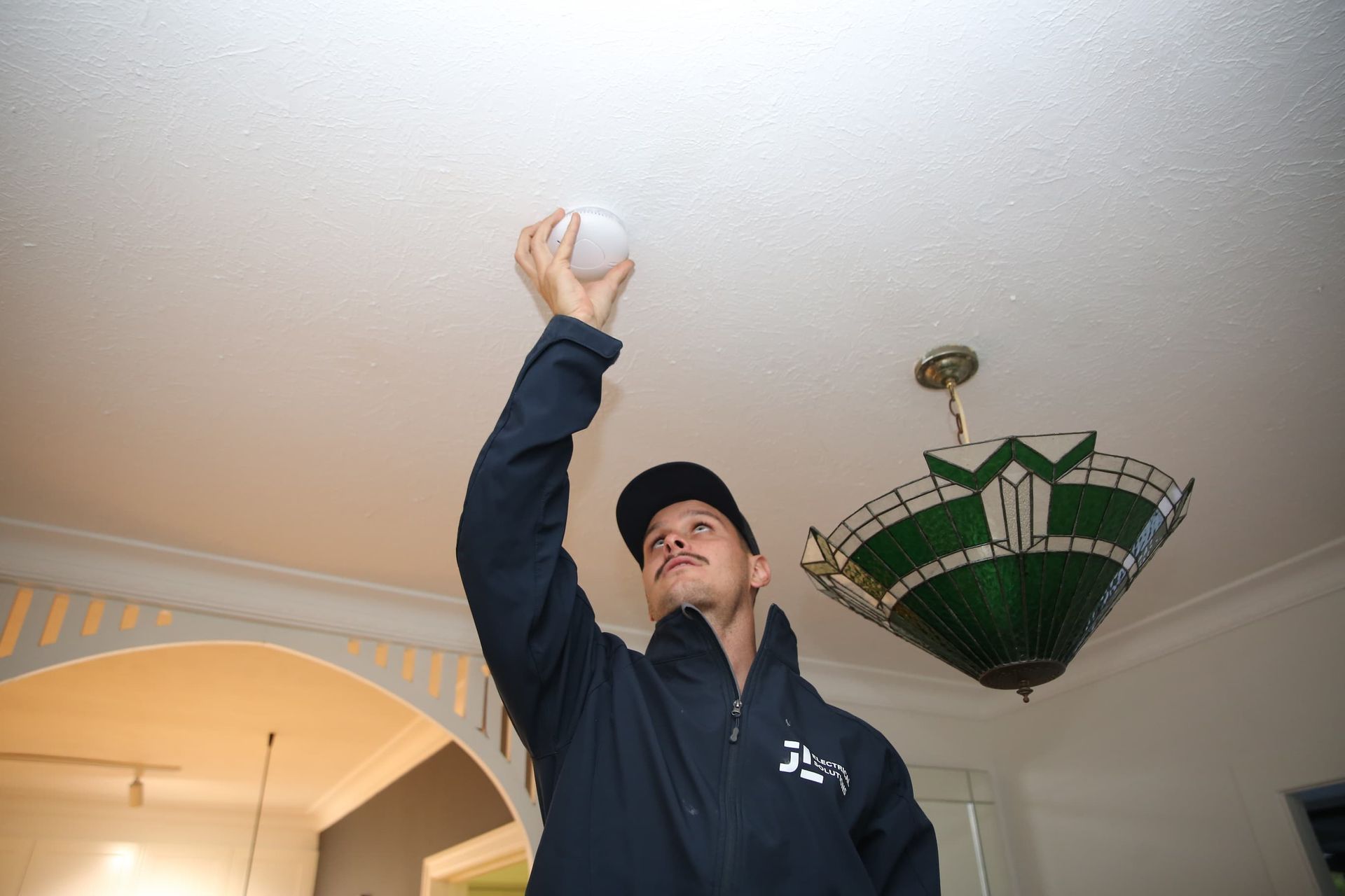 Electrician Checking Smoke Alarm - Electrician Gold Coast