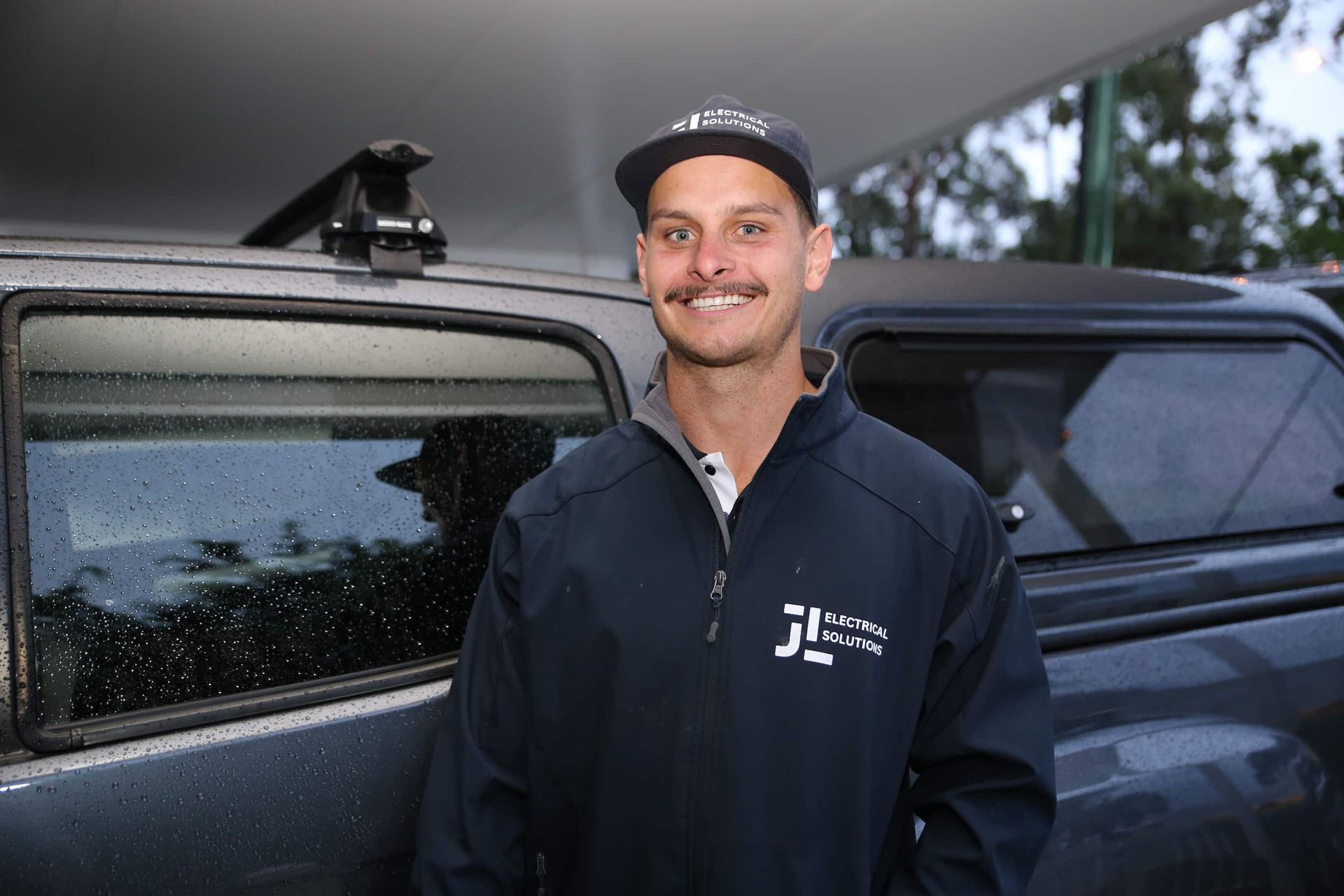 Electrician in front of work vehicle - Electrician Gold Coast