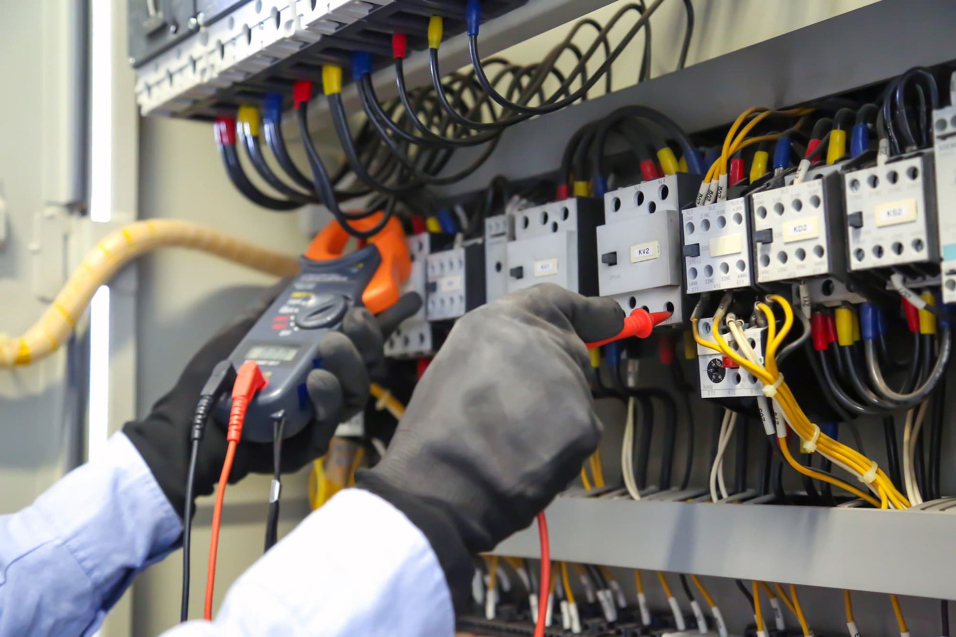 Electrician using a multimeter- Electrician Robina