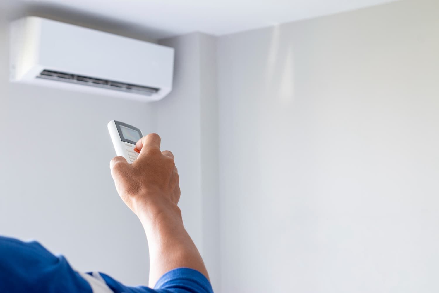 Person turning on an air conditioner