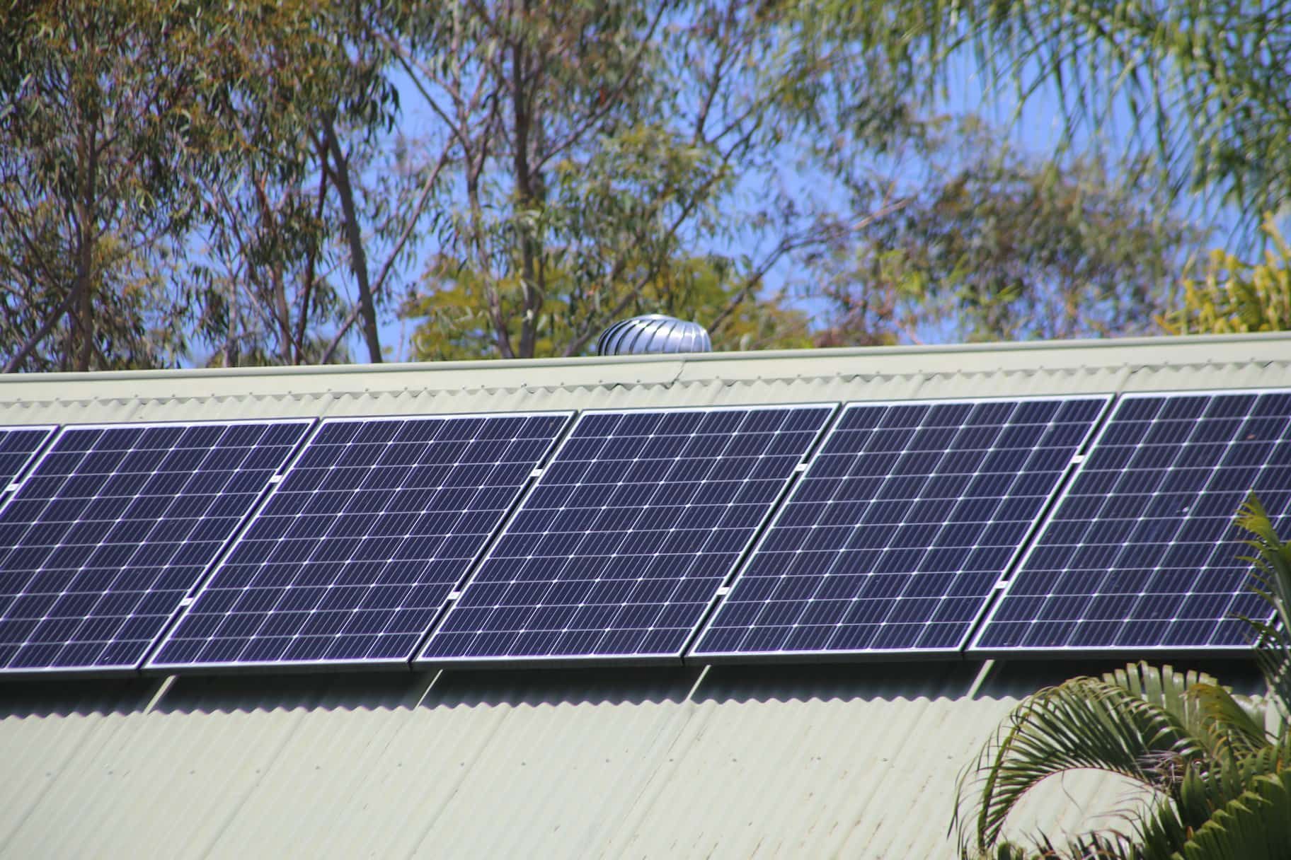 a row of solar panels on the roof of a building