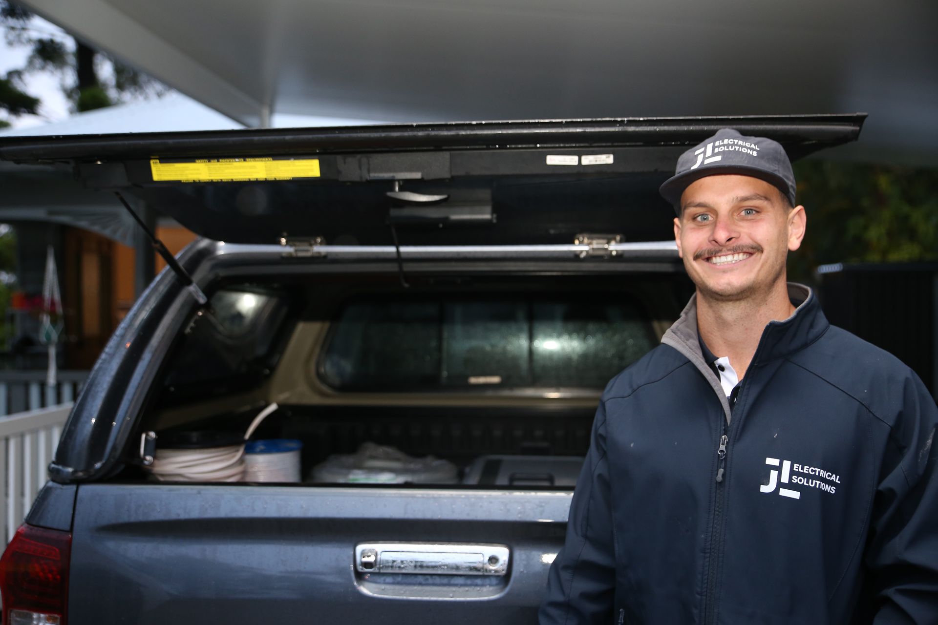 Electrician in front of work vehicle - Electrician Gold Coast