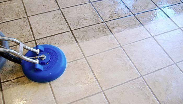A tile floor is being cleaned with a machine.