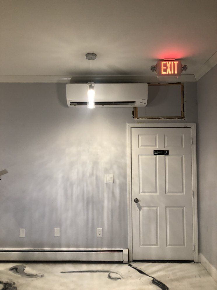 a room with a red exit sign above the door