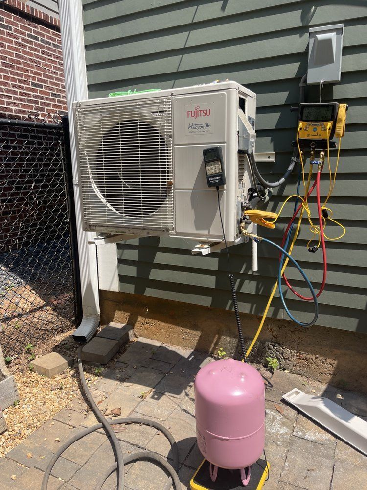 an air conditioner is being installed on the side of a house .