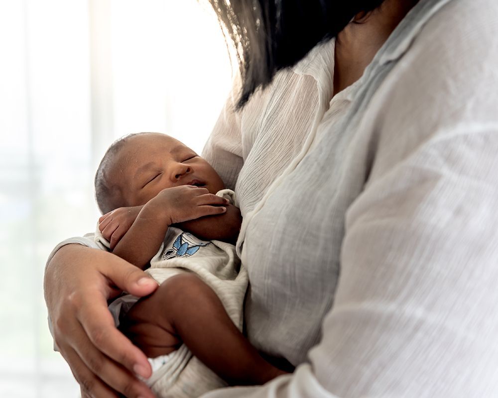 Woman is Holding a Newborn Baby