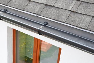 Mesh gutter guard on roof