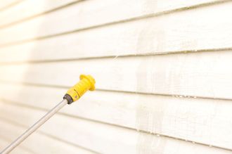 Pressure washing siding.
