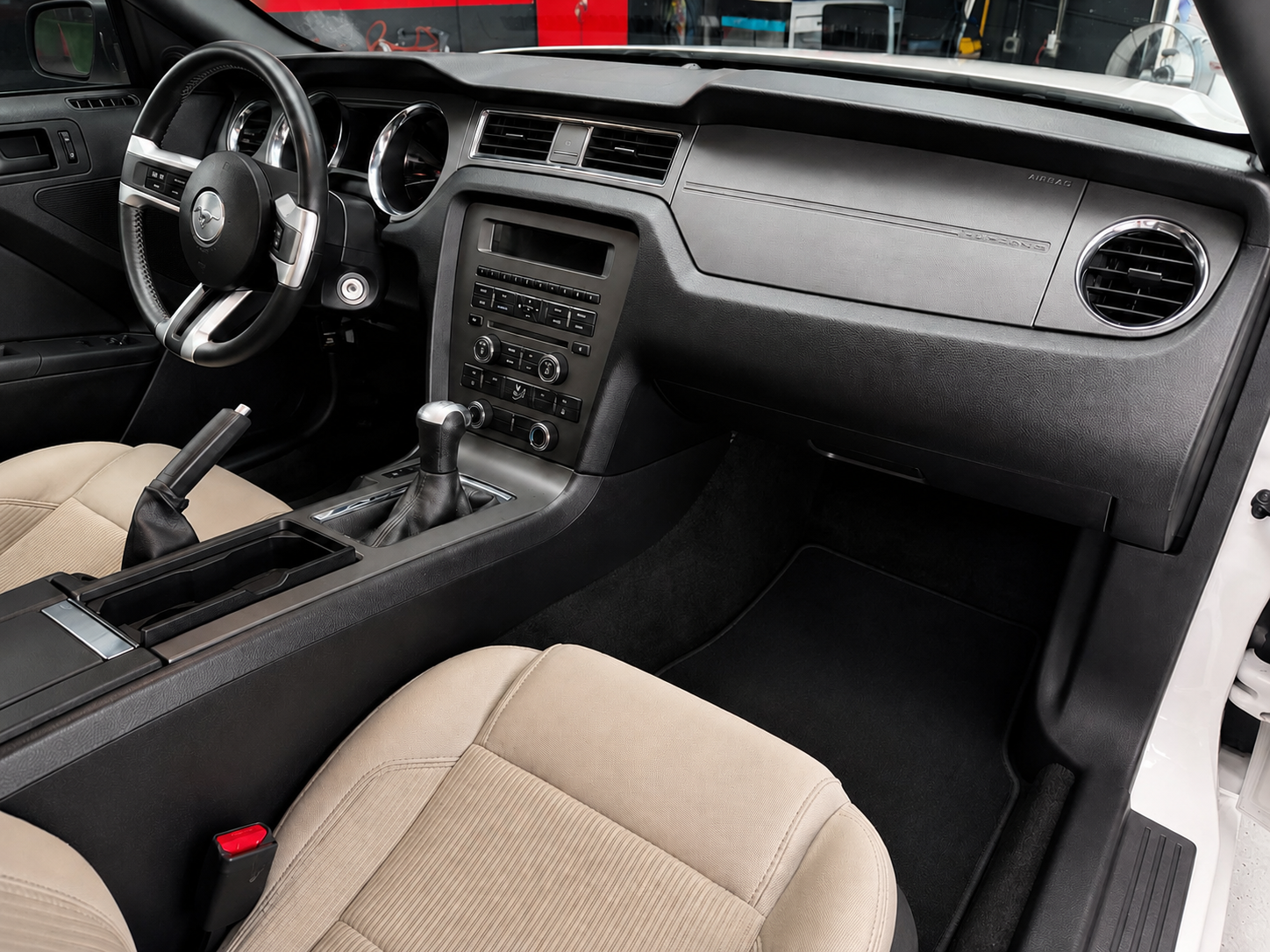 Professional car interior detailing service in Newnan, GA showcasing a restored dashboard and clean leather seats.