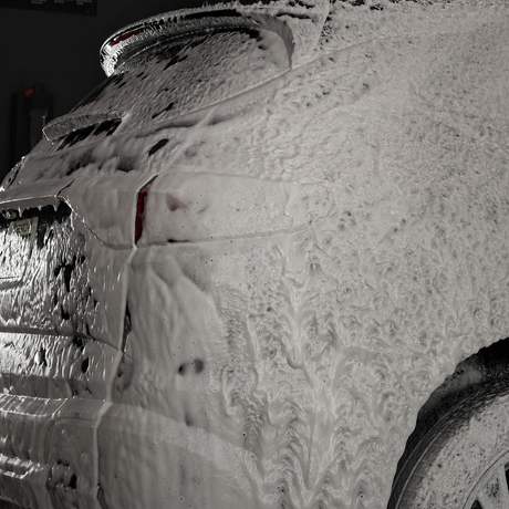 Vehicle covered in soap being prepped for coating