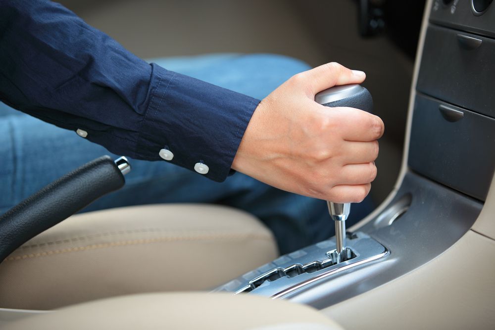 A Person’s Hand Shifting an Automatic Car Gear Lever — Roberts Automotive & Industrial in Brighton, TAS