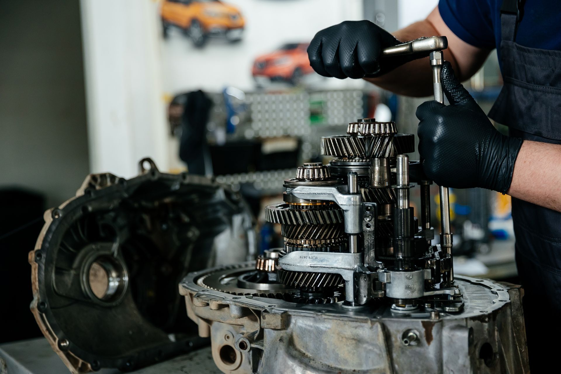 A Mechanic Uses a Wrench to Work on the Exposed Gears of a Car Transmission — Roberts Automotive & Industrial in Brighton, TAS