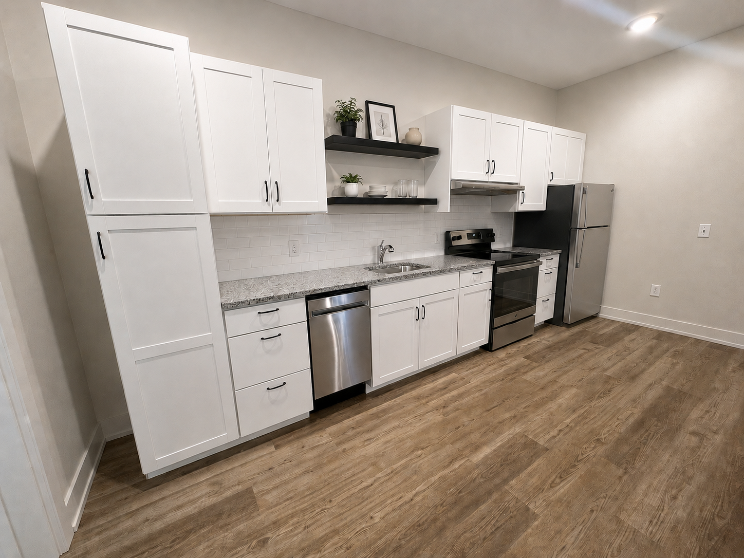 Kitchen with stainless steel appliances and modern cabinetry at Bradford Station Apartments