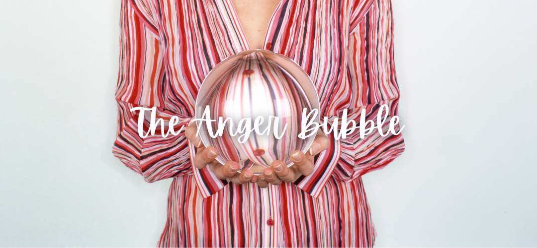 a woman in bright red and white striped shirt holds a glass ball representing the Anger Bubble