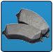 Gray brake pads on blue background. | Quality Car & Truck Repair