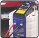 Battery charger with red and black cables connected. Blue and black charger on a white object. | Quality Car & Truck Repair
