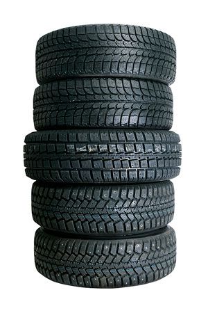Stack of six black tires with tread. | Quality Car & Truck Repair Inc