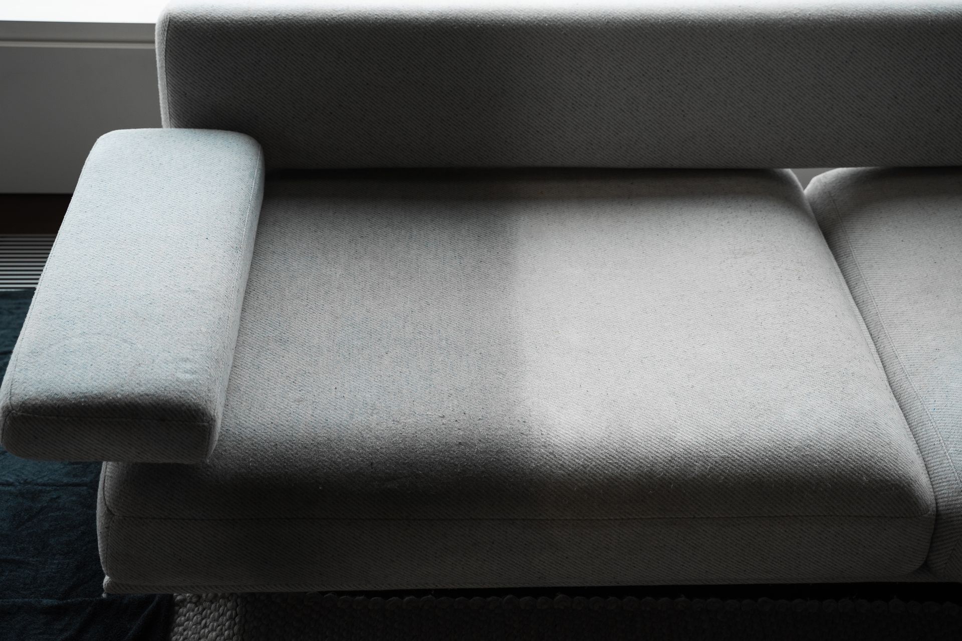 Modern gray sofa with rounded armrests and seat cushions