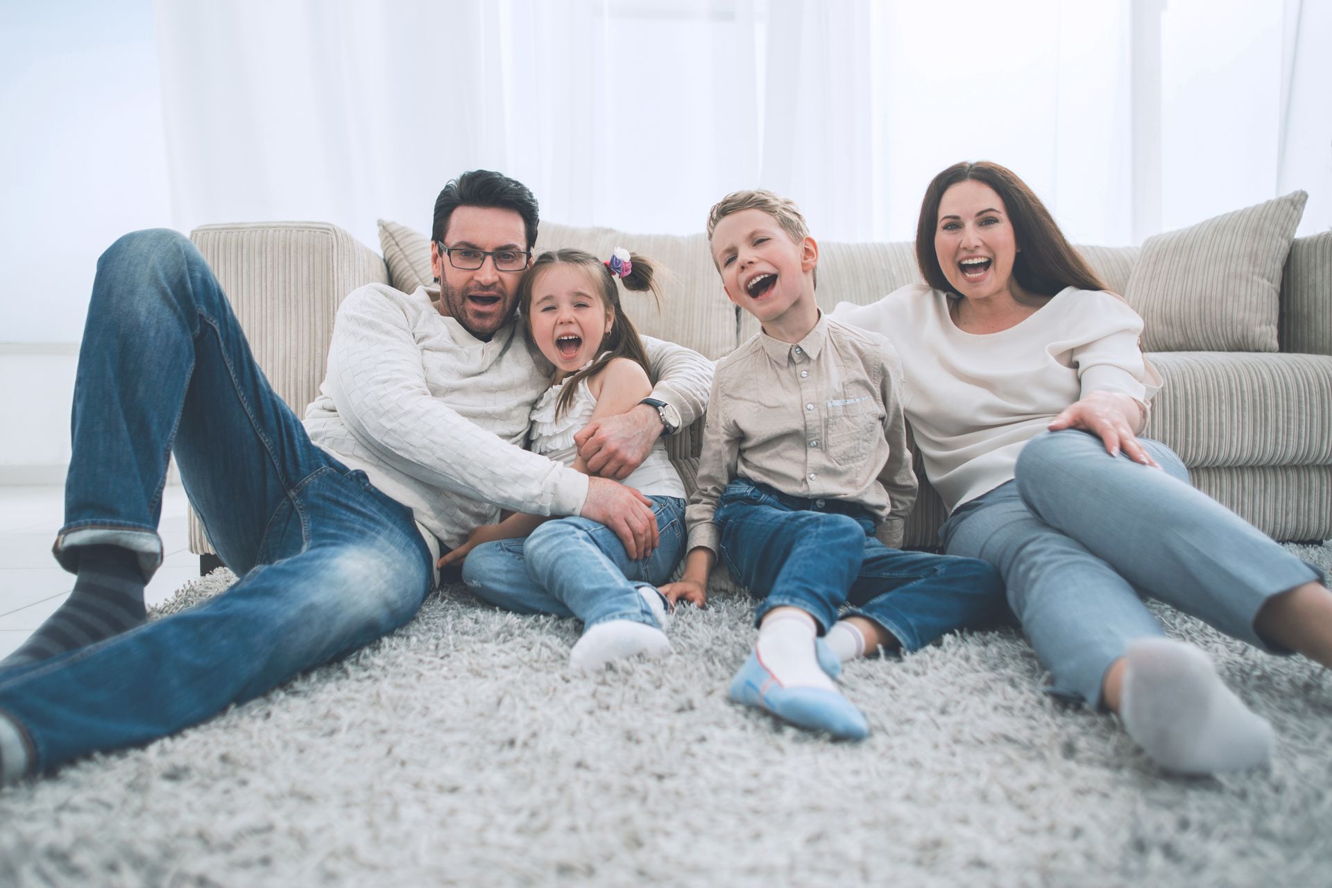 family sitting on carpet floor