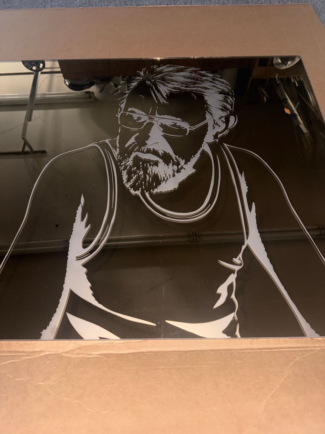 White line-art portrait on a dark surface, showing a seated person with short hair and a sleeveless shirt.