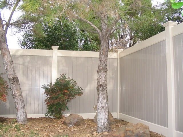 A fence with a tree in the middle of it