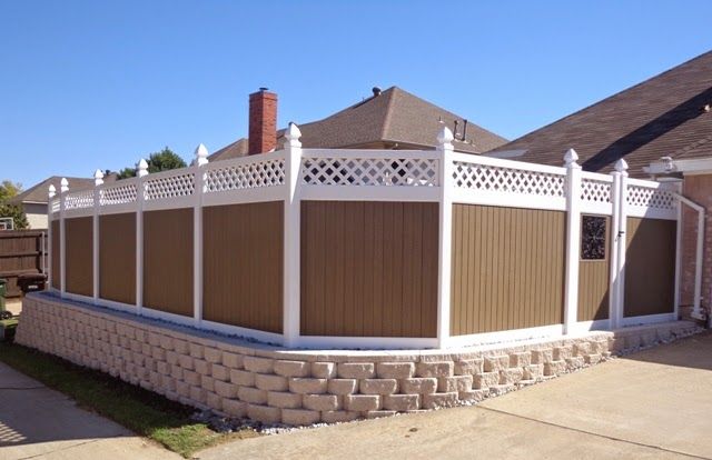 A brown and white fence in front of a house