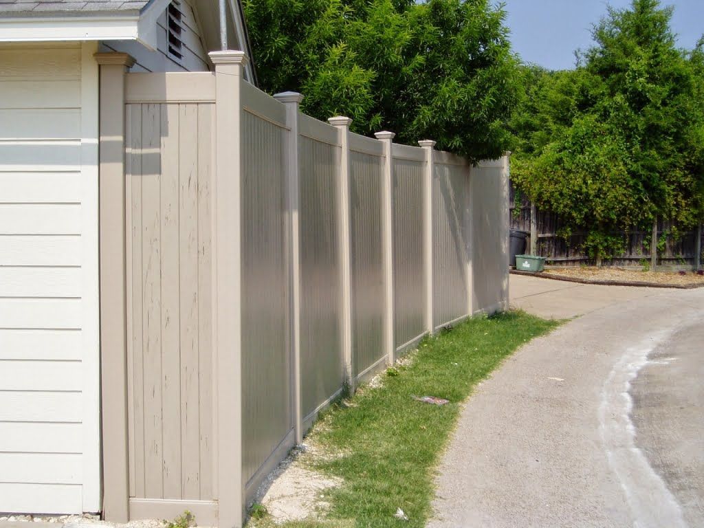 A white fence along the side of a road