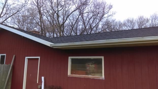 A red house with a roof and a window