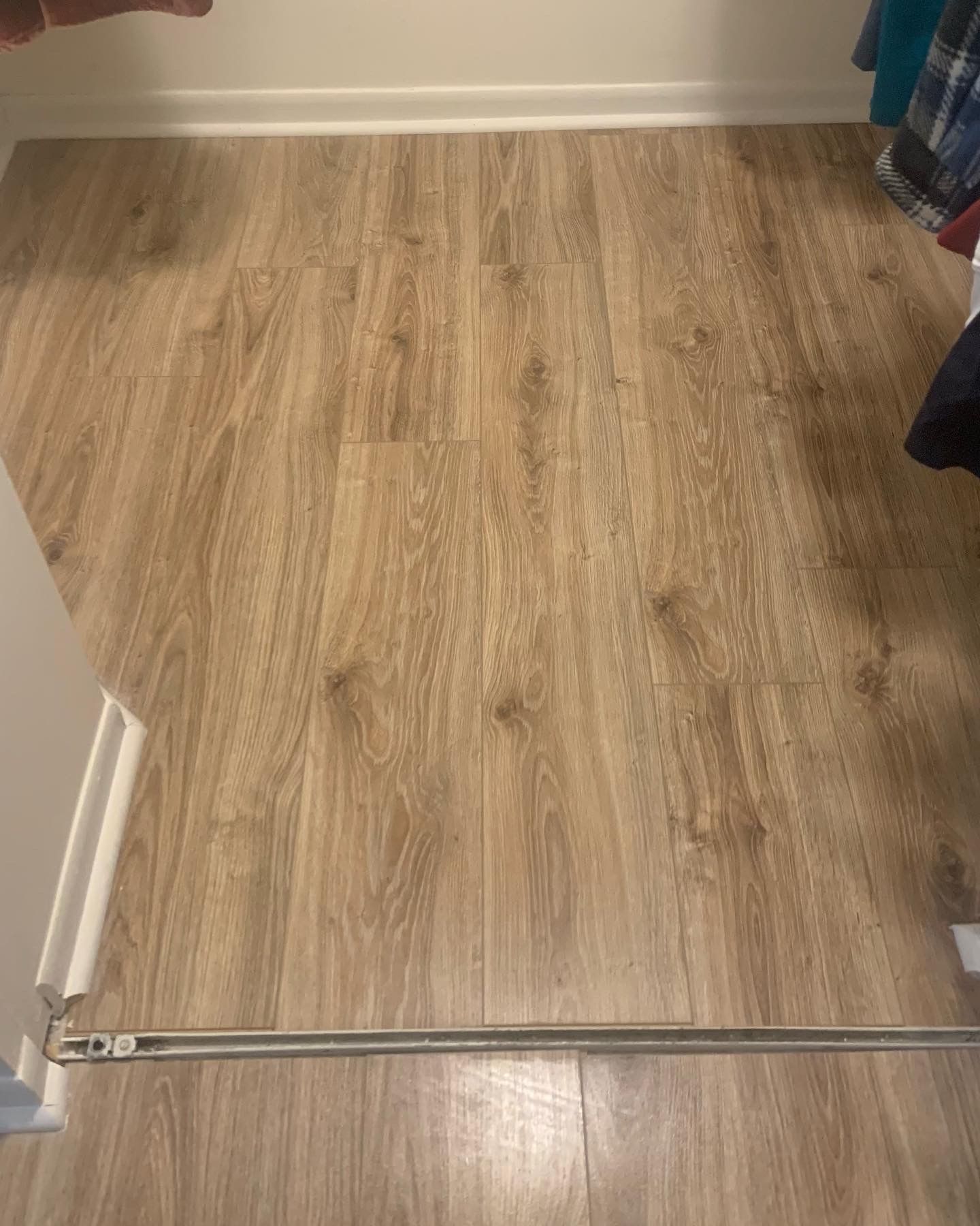 Empty room with light wood flooring and a doorway threshold