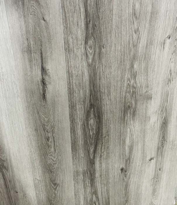 Close-up of gray wood-grain textured surface with vertical streaks and knots