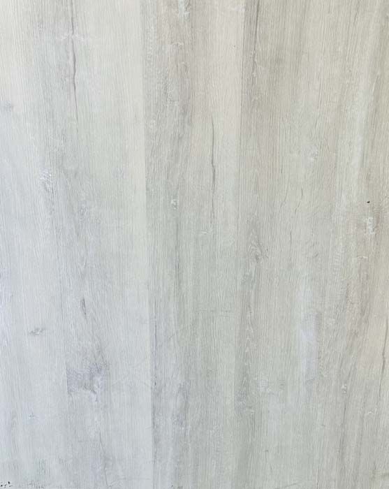 Close-up of a light gray wood-grain surface with subtle vertical streaks.
