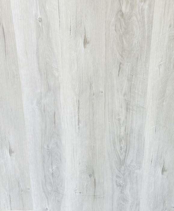 Light gray wood-grain paneling with vertical planks.