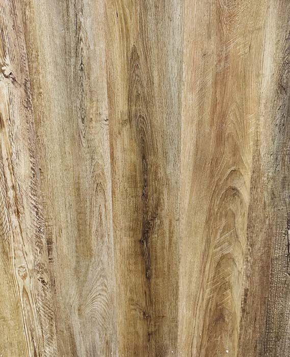 Close-up of wood grain with tan, brown, and gray streaks and vertical texture