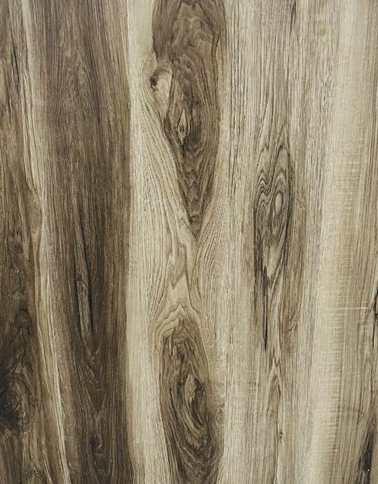 Close-up of light brown wood grain with dark knots and vertical streaks