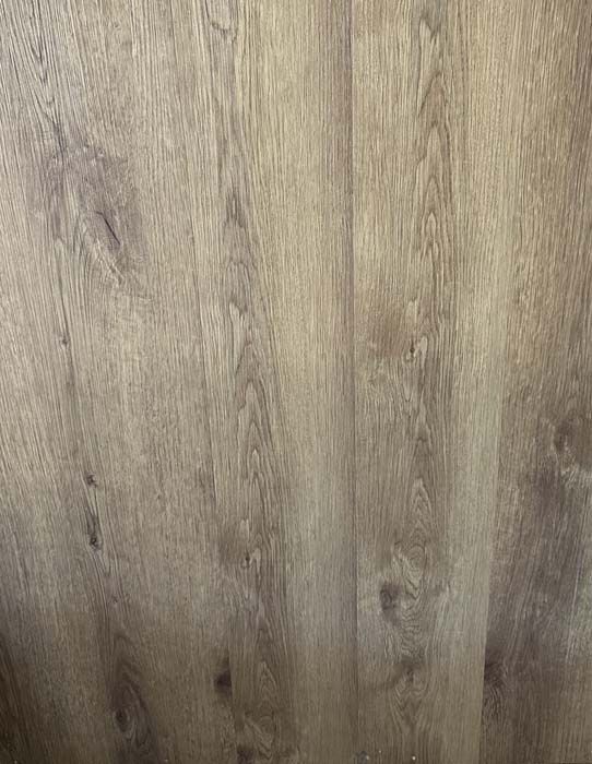 Close-up of light brown wood grain with knots and vertical planks