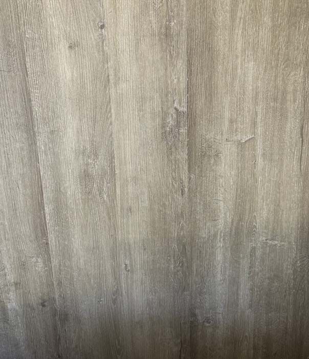 Close-up of gray wood-grain paneling with a subtle vertical texture
