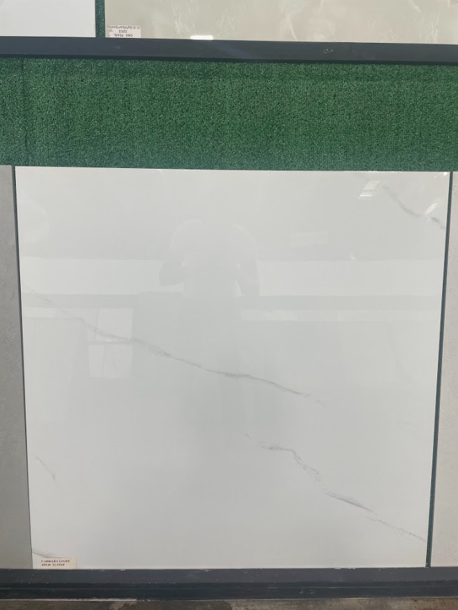 Whiteboard with faint reflections and a few light scratches, mounted below a green textured wall strip.