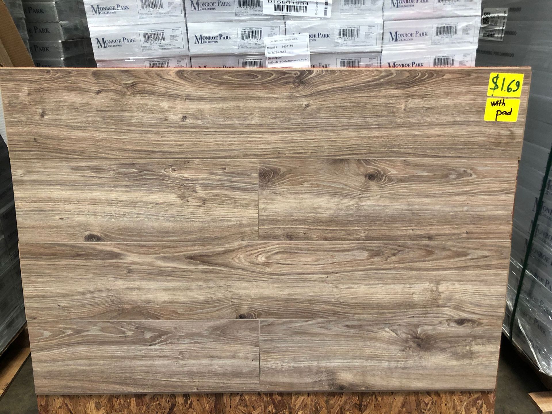 Large wood-look tile or panel leaning in a store aisle, with a yellow price tag in the top right.