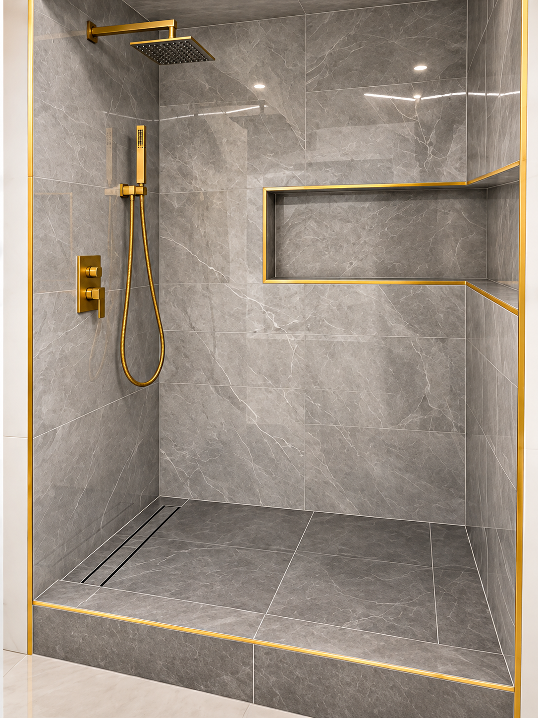 Walk-in shower display with large-format gray tile and gold fixtures in Fort Lauderdale showroom