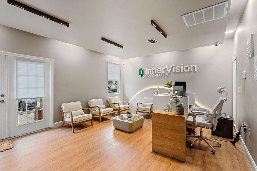 Bright ophthalmology office with reception desk, seating, and exam chair on wood floors