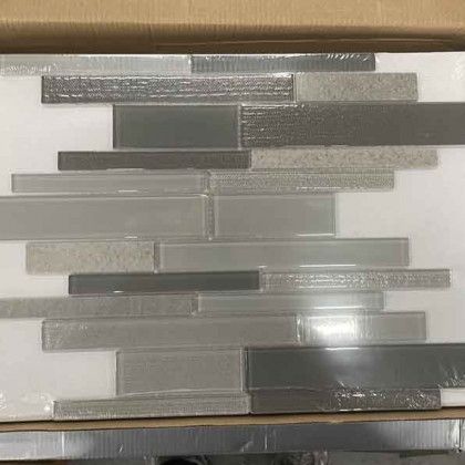 Gray and silver stacked rectangular tiles on a white wall