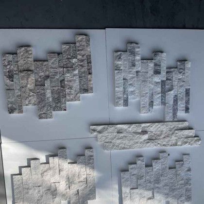 Four textured paper samples with gray, white, and stone-like patterns arranged in a 2x2 grid.