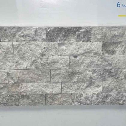 Gray stacked stone wall tile sample with textured rectangular blocks