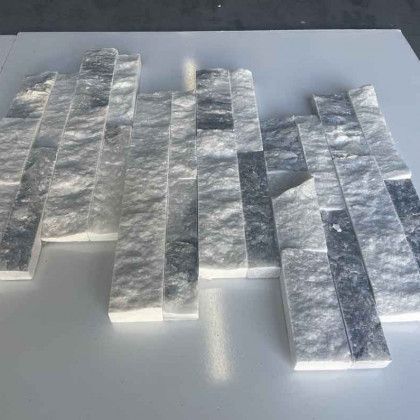 Several translucent gray textured strips arranged overlapping on a light surface.