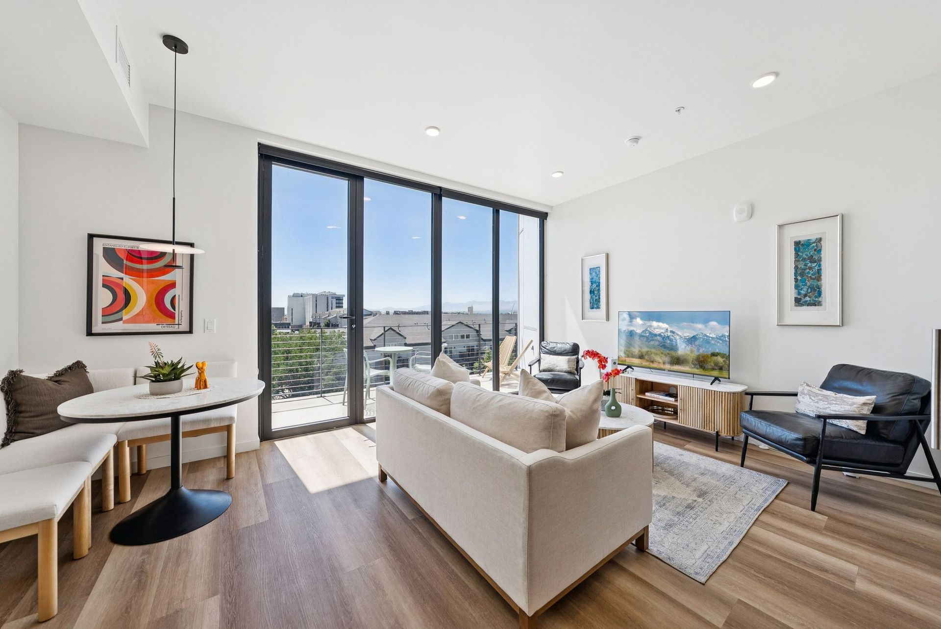 Aperture Residences | Euro 1 dining and living room rendering looking out to the balcony through floor to ceiling windows.