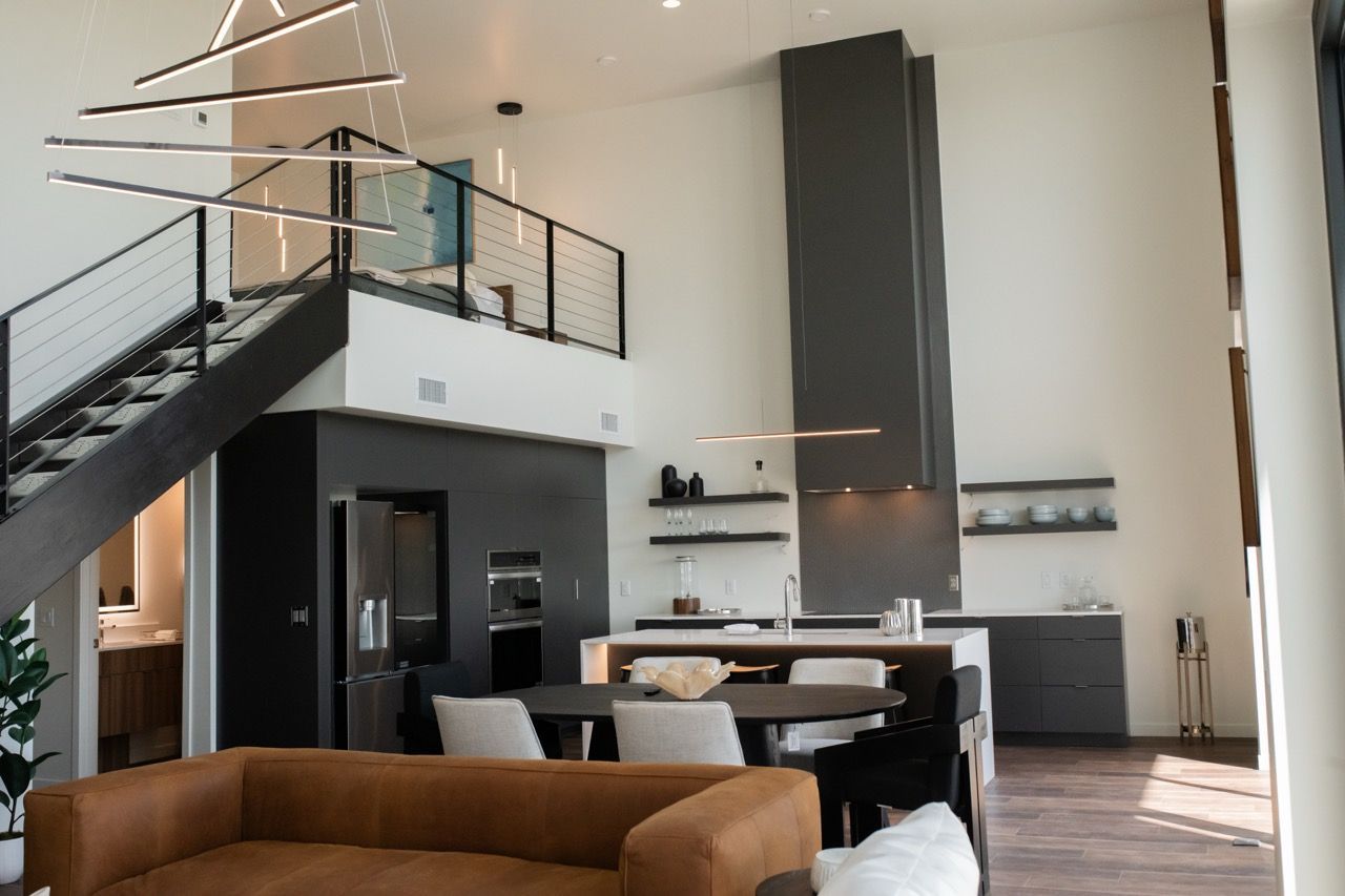 Aperture Residences | Euro 1 dining and living room rendering looking out to the balcony through floor to ceiling windows.